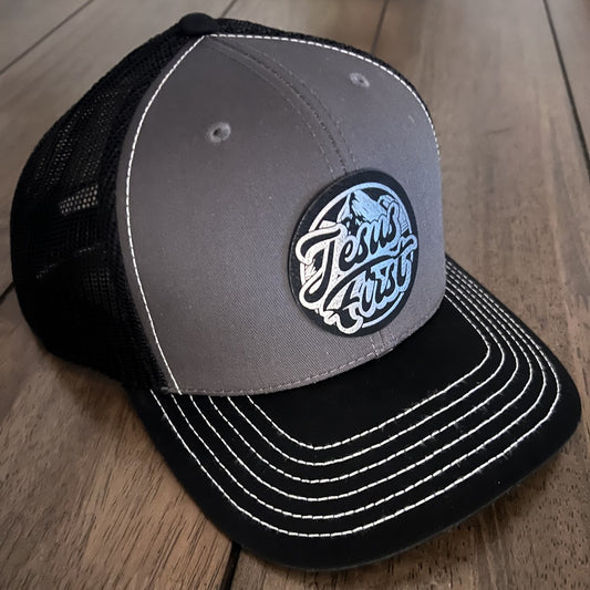Jesus First - Mesh Back Trucker Hat Leather Patch - Black/Grey