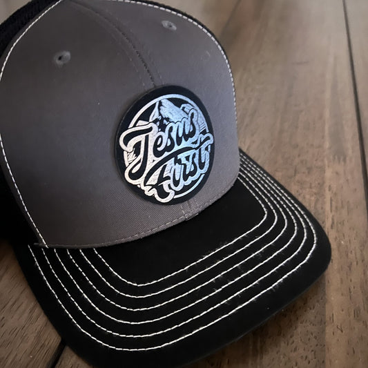 Jesus First - Mesh Back Trucker Hat Leather Patch - Black/Grey